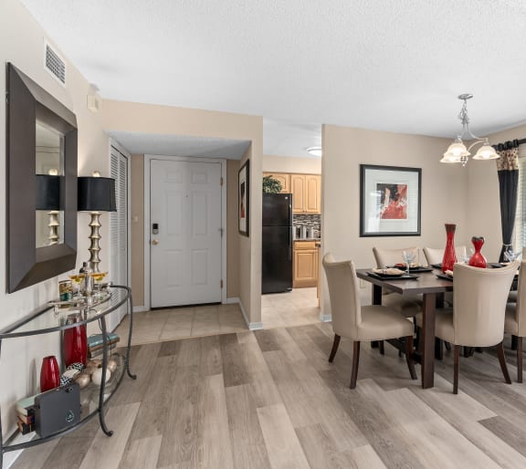 the living room and dining room of a home with a table and chairs at Oak Reserve at Winter Park, Florida