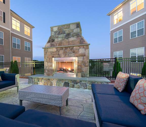 Outdoor fireplace lounge with soft seating