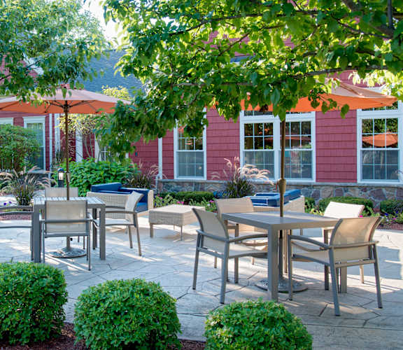 Outdoor patio seating with lush landscaping