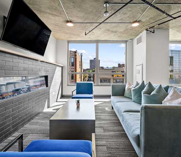 a living room with a fireplace and a large window at Lakeview 3200 Apartments, Chicago, IL, 60657