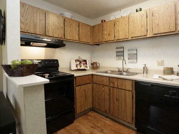 a kitchen with a stove top oven next to a sink