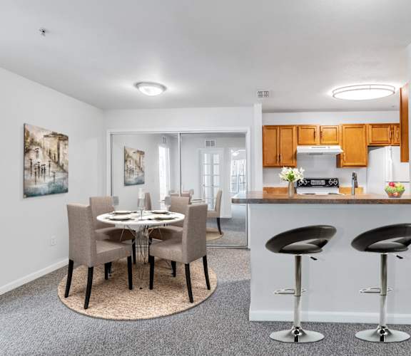 a dining room and kitchen with a table and chairs