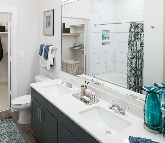 a bathroom with a sink and a toilet and a mirror at Gatsby on Ross, Dallas, Texas
