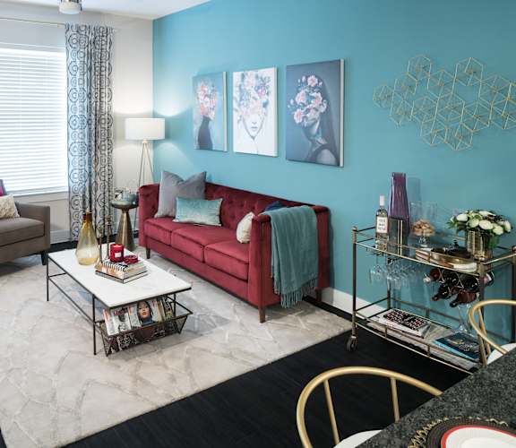 a living room with blue walls and a red couch at Gatsby on Ross, Dallas, Texas