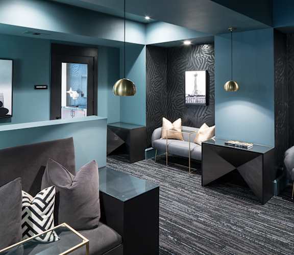 a living room with couches and a table at Gatsby on Ross, Dallas, Texas