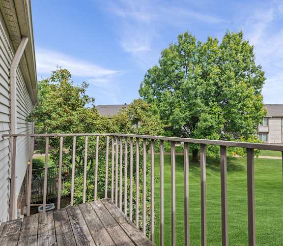the view from the deck of a home with a yard and a tree at Edge At Farmington Hills - Farmington Hills, MI, Michigan, 48334