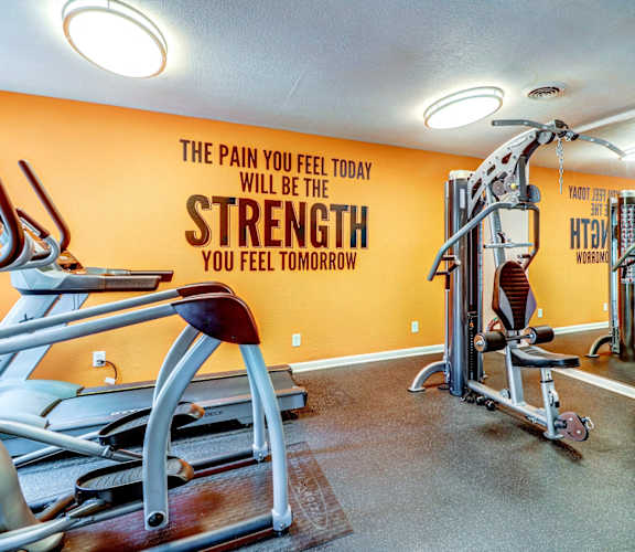 the gym at the district at highland village apartments