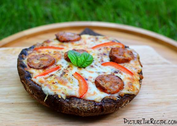 a pizza sitting on top of a wooden cutting board