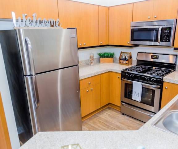 Fully Equipped Kitchen Includes Frost-Free Refrigerator, Electric Range, & Dishwasher at Medici Apartment Homes, Bermuda Dunes, California
