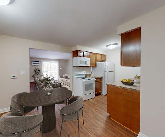 A dining room with a table and chairs.