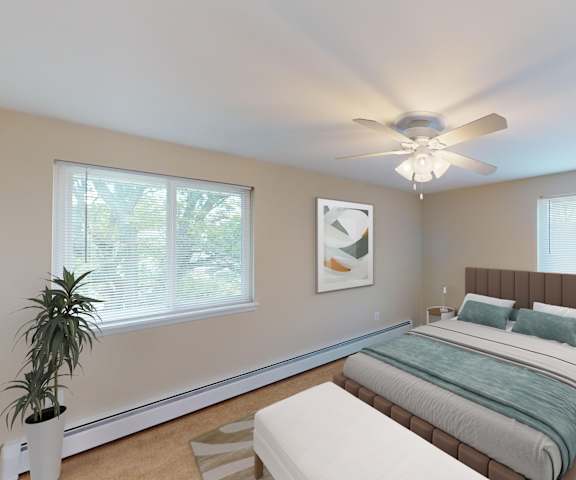 a bedroom with a large bed and a ceiling fan