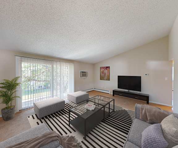 the living room of an apartment with a couch and a tv