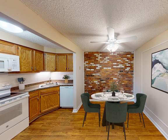 a kitchen and dining room with a table and a ceiling fan