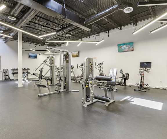 a gym with weights and other exercise equipment in a building