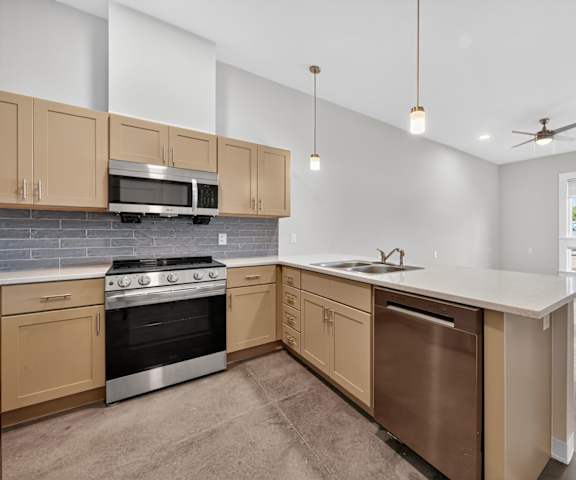 A kitchen with a stove, oven, and microwave.