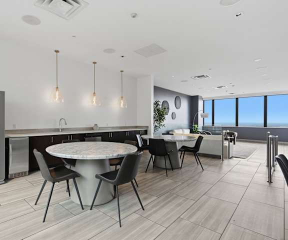 A modern kitchen with a dining table and chairs.