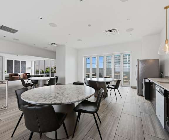 A modern kitchen with a dining table and chairs.