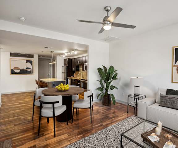 A modern living room with a dining table and chairs.
