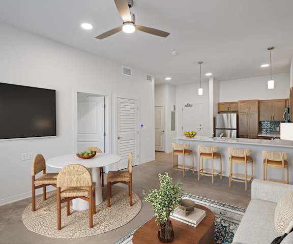 A modern living room with a dining table and chairs.