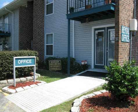 A sign that says "Office" stands in front of a building.