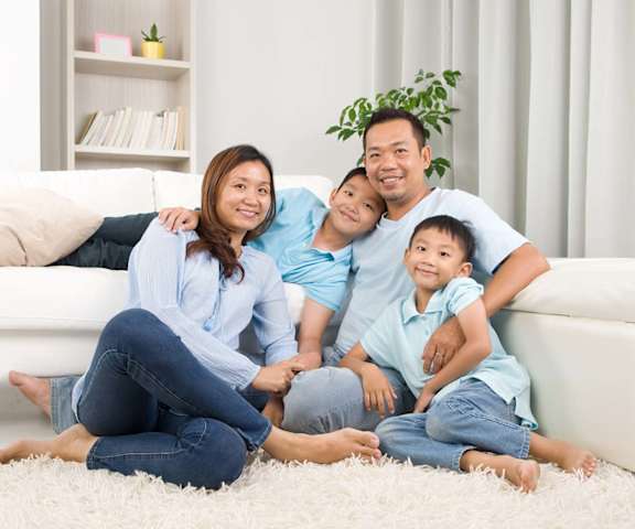 Family of four lounging in the living room