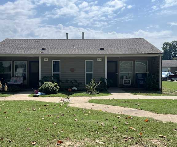 a house with a porch and a grass yard