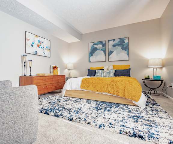 a bedroom with a bed and a couch
