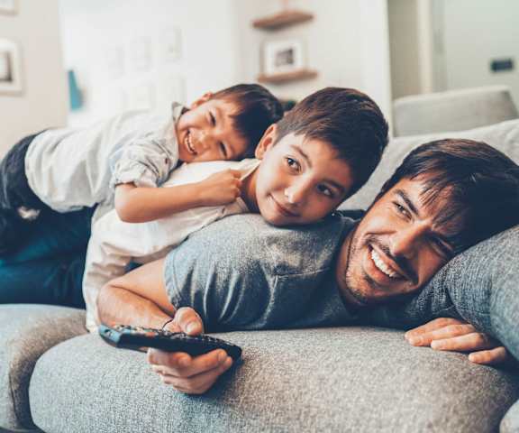 stock image- family on couch watching TV