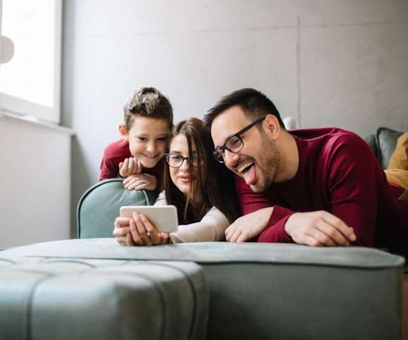 stock image- family on couch with phone
