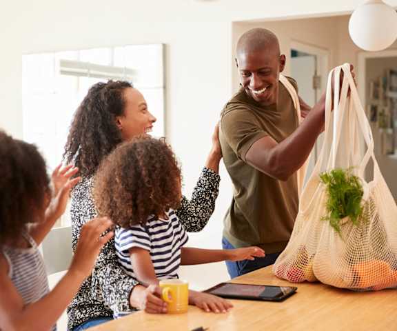 stock image- family in kitchen after grocery shopping