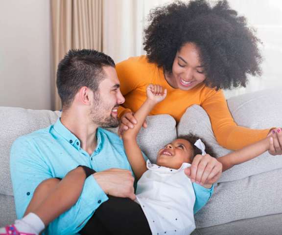 stock image- family in living room on couch