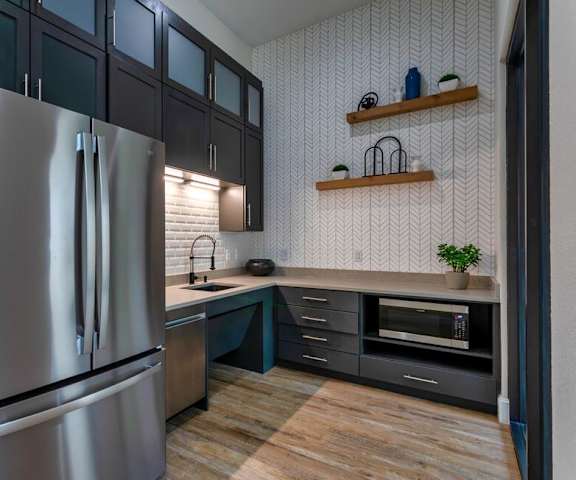 a kitchen with stainless steel appliances and black cabinets