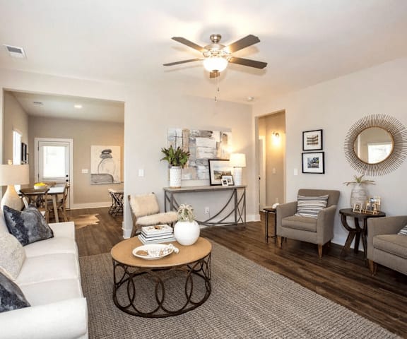 A living room with a white couch and a coffee table.