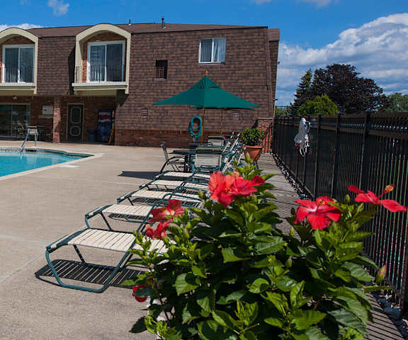 our apartments have a swimming pool and a patio with chairs