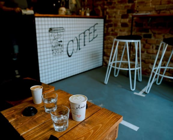 Cafe with table, chairs, and register area