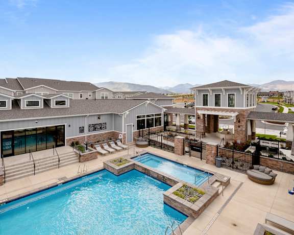 a large swimming pool with a building in the background