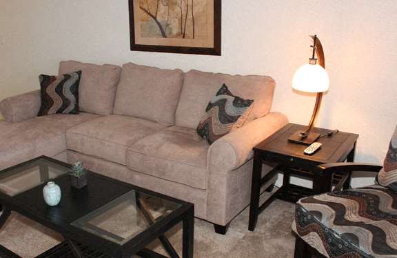 a living room with a couch and two tables