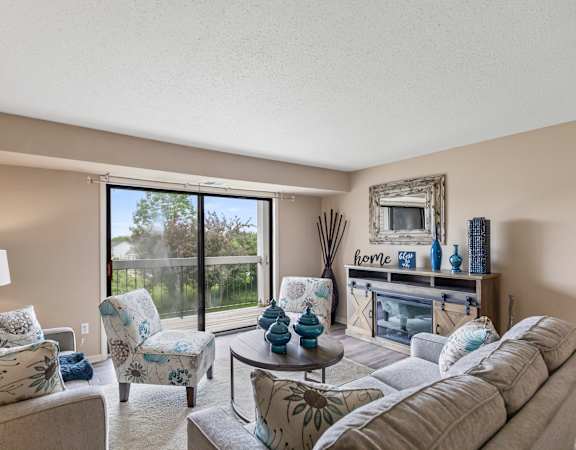 A living room with a couch, chairs, and a coffee table.