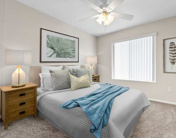 a bedroom with a large bed and a ceiling fan