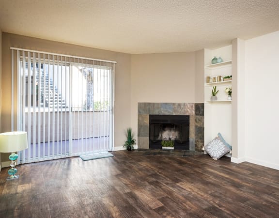 a living room with a fireplace and a large window