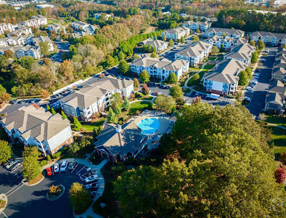 a aerial view of a neighborhood with houses and a swimming pool