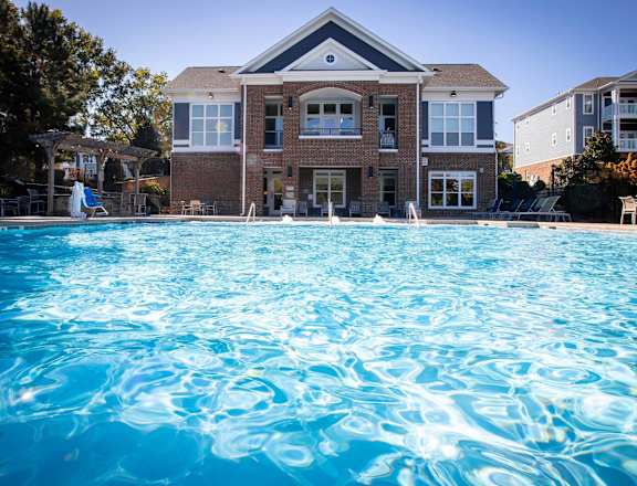a large swimming pool in front of a house
