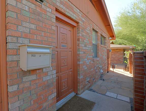 a brick building with a mailbox on the side of it