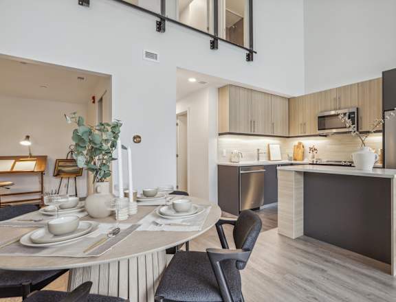 an open kitchen and dining room with a table and chairs