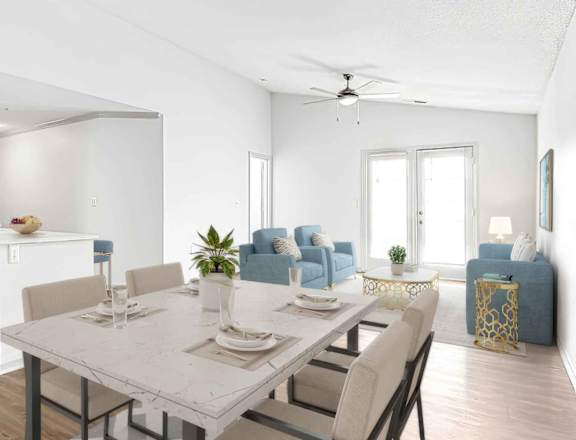 A modern kitchen with a dining table set for two.