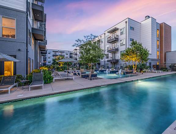 a swimming pool with apartments in the background