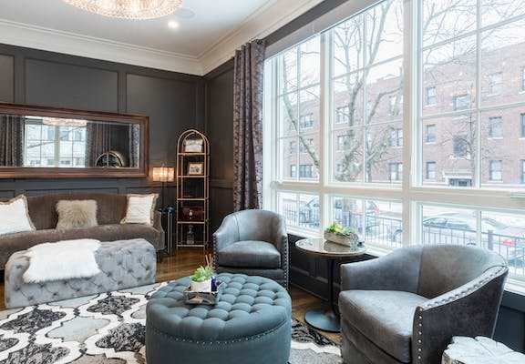 a living room filled with furniture and a large window