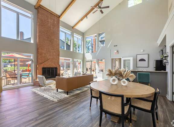 A modern dining room with a wooden table and chairs.