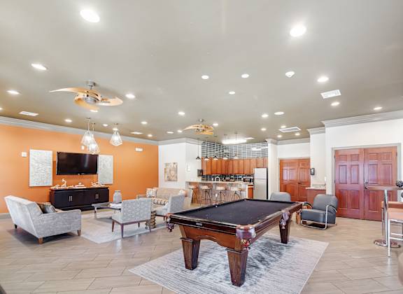 a game room with a pool table and a bar at Cumberland Place Apartment Homes, Texas