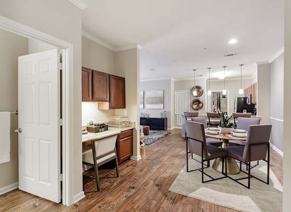 a living room and dining room with a table and chair at Cumberland Place Apartment Homes, Tyler, TX